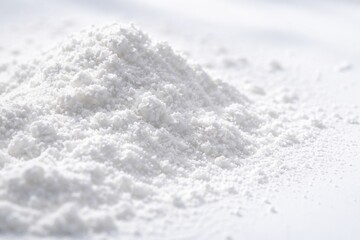 Obraz premium macro image of fine powdered sugar dusted on clean white backdrop under natural light