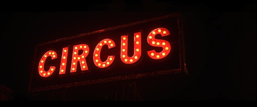 Phantasmal classic circus sign shining eerily in the night glow