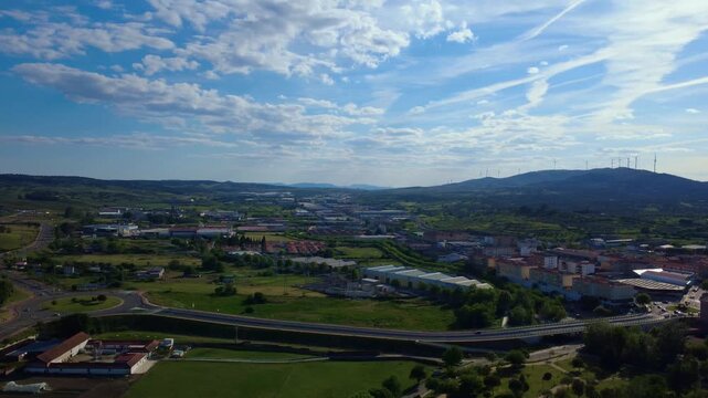 Aerial pan from industrial district to medieval spanish city