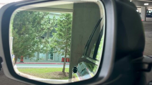 Reflection of passing traffic in parked car side mirror