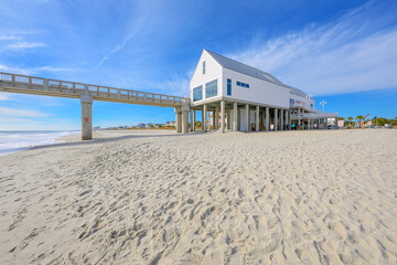 View from the sandy beach of the Grand Strand along the Atlantic Ocean of the Surfside Beach Pier and waterfront, in Surfside Beach, South Carolina. © Kirk Fisher
