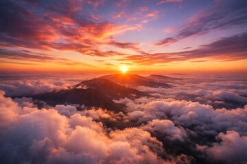 Fototapeta premium Sunset scene from above capturing vibrant sky hues over fluffy white clouds and remote mountains with ample copy space
