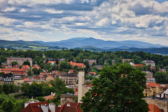 Scenic town panorama with mountains and dramatic cloudy sky; klodzko, poland, lower silesia, dolny slask,