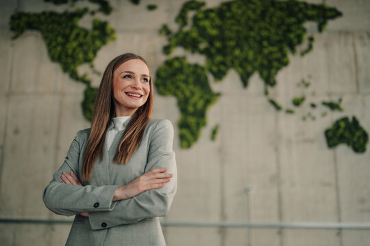Businesswoman looking ahead, embracing global sustainability and green initiatives with confidence