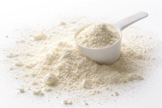 White background showing colostrum based skim milk powder with natural spilled texture for health ads