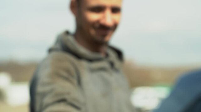 Man holding small new car light bulb on street, auto parts repair and replacement concept.