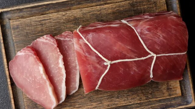 Smoked or dry cured meat slices, pork or ham with salt and spices. Smoked meat slices as a food background for your design