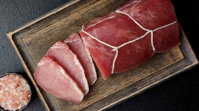 Smoked or dry cured meat slices, pork or ham with salt and spices. Smoked meat slices as a food background for your design
