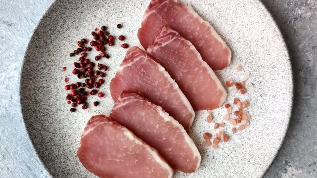 Smoked or dry cured meat slices, pork or ham with salt and spices. Smoked meat slices as a food background for your design