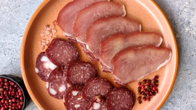 Smoked or dry cured salami slices or ham with salt and spices. Smoked sausage slices as a food background for your design