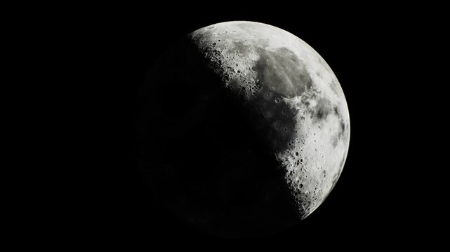 A stunning view of the moon, partially illuminated and surrounded by the vast darkness of the night sky. Its craters and texture are visible, captivating all who look up in wonder.
