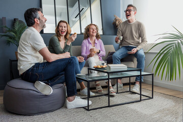Naklejka premium group of senior friends having fun at home, Diverse group of hispanic middle aged people on sofa indoors