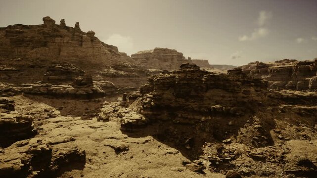 Wild rugged landscape. Deserted rocky valley scene. Vast arid terrain with sharp cliffs. Expansive borderlands filled with jagged stone formations and shadows