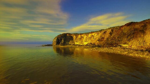 Golden arch reflection over calm sea, warm cinematic tones and glossy foreground create minimal composition ideal for hero banners, headers and commercial
