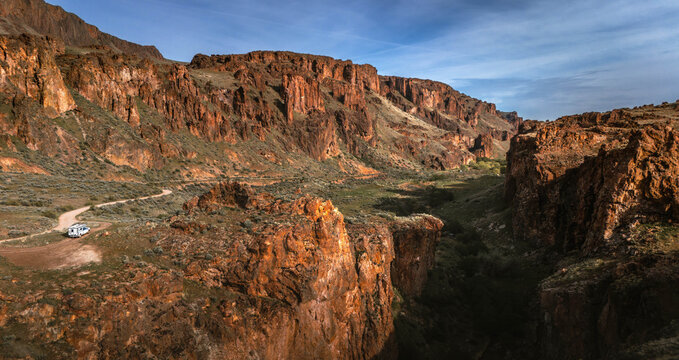Truck Camper on Dirt Road Through Red Rock Canyon at Golden Hour, Leslie Gulch Oregon