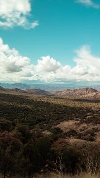 Arizona near the Mexican border. Vertical time-lapse of dramatic cumulus clouds racing over the forested Patagonia Mountains, viewed from Duquesne Road in Coronado National Forest.