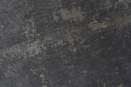 Close-up view of weathered, cracked concrete floor in urban decay scene, dominated by grayscale hues with a subtle blue tint and no visible objects