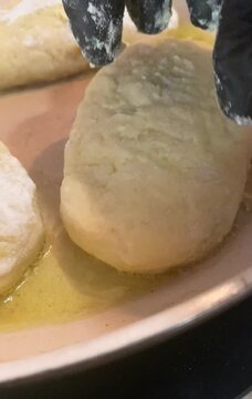  Perfect golden-brown crust! Close-up of flipping potato zrazy (stuffed potato pancakes) in a frying pan with oil. Cozy home cooking video.