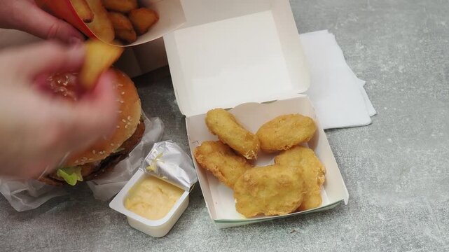 Fast food delivery menu background with various burgers, cheeseburger, nuggets, french fries, fizzy soda drinks. Junk unhealthy fast food, Ultra processed food with low nutrition, high calories value