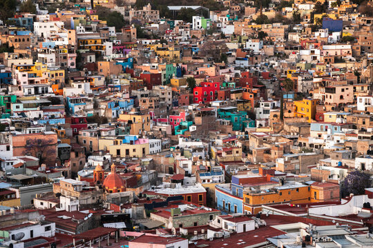 Vibrant hillside view of colorful colonial architecture in Guanajuato Mexico at sunset showcasing urban landscape and cultural heritage