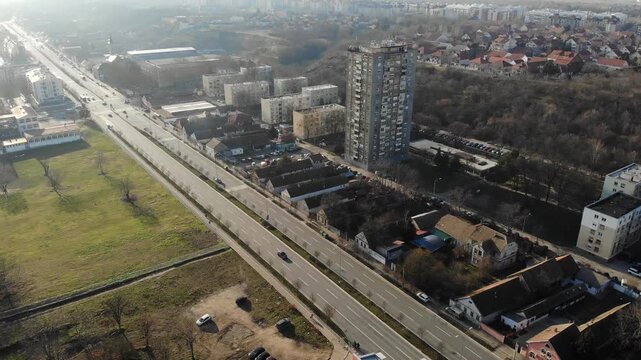 Aerial perspective of wide city boulevard with traffic in New Belgrade, Serbia, sunny afternoon.