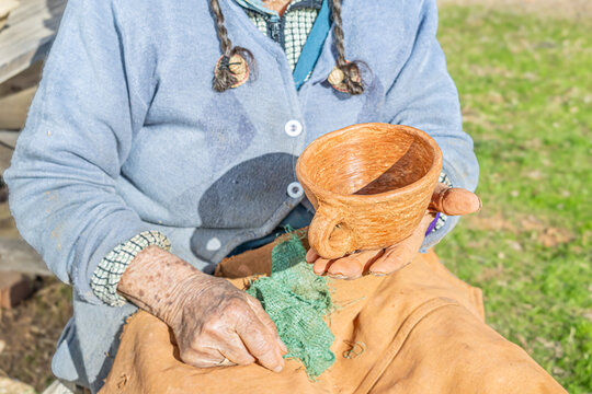 Cauquenes, Chile - March 26, 2026: An artisan showing her finished work, a clay cup.