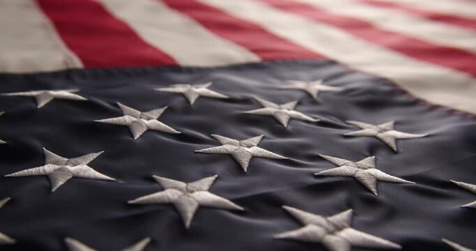 Video of a real American flag close-up. Fresh unfolded flag of the United States of America in bright light.

