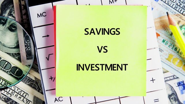 A close-up view of a sticky note comparing savings and investment, placed on United States dollar currency and a calculator for financial analysis