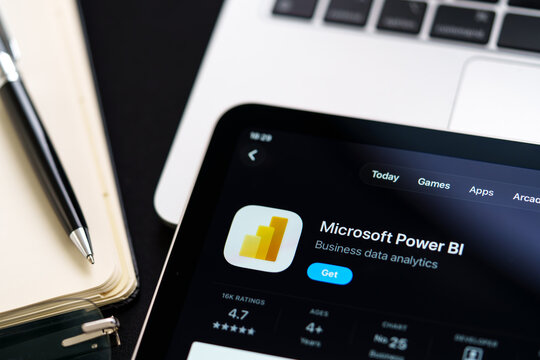 Microsoft Power BI closeup on iPad showing Apple Liquid Glass updated look and iOS 26 App Store design on desk. Stafford, United Kingdom, April 13, 2026.