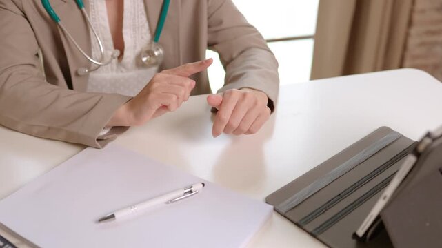 Doctor hands talking during patient consultation at desk