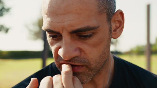 nervous man biting his nails