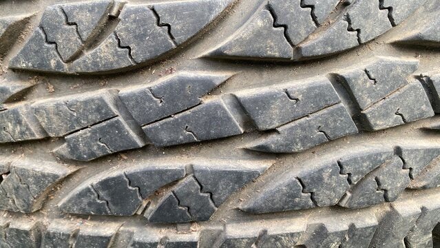 Close Up Texture of Dirty Off-Road Car Tire Tread with Dust