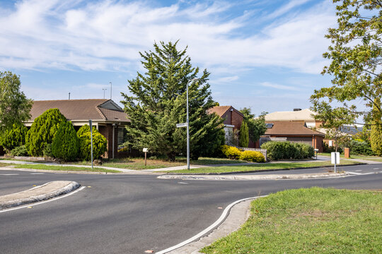 A suburban residential street in Melbourne Australia featuring a chicane road deflection traffic calming design with a landscaped kerb blister island, forcing vehicles to slow down