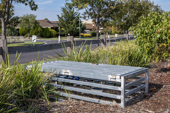 A galvanised steel protective guard frame enclosure installed over underground water pipe or utility infrastructure in a suburban&nbsp;park in Melbourne Australia,&nbsp;residential homes in the background.