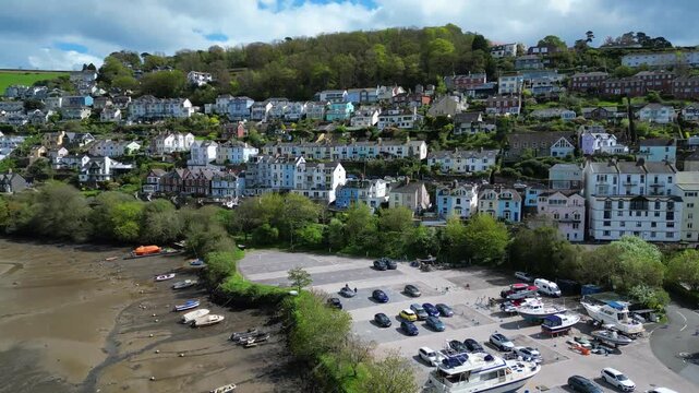 
Kingswear, Devon, England: DRONE VIEWS: Waterhead Creek; Darthaven Marina dry dock and car park; Houses on hillside overlooking the Creek. South Devon is a popular UK holiday destination.