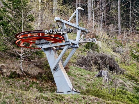 Weathered metallic components forgotten among densely vegetated and rugged mountain terrain