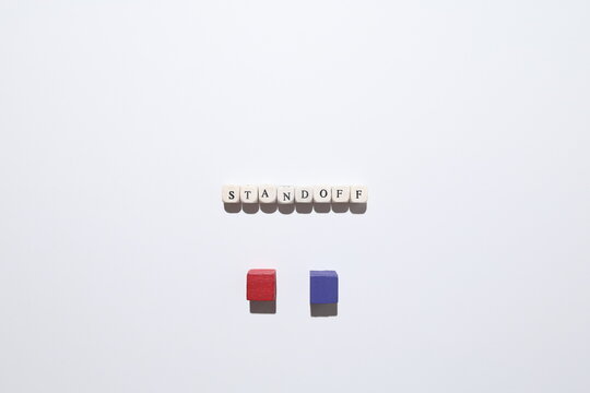 STANDOFF word with red and purple cubes representing deadlock, confrontation and unresolved conflict.