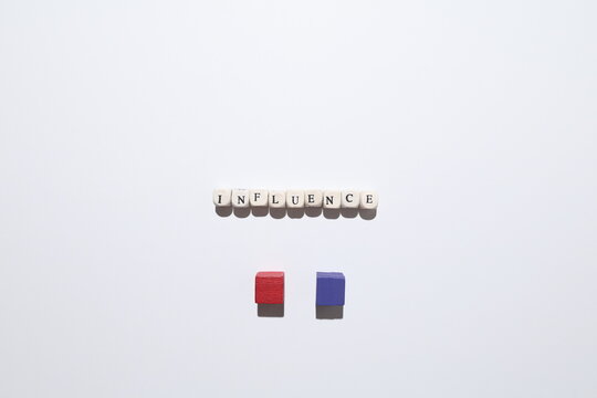 INFLUENCE text with red and purple cubes representing power, persuasion and impact between opposing groups.