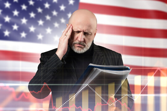 Economic analysis, Financial risk assessment. Businessman reviews documents against US flag and market charts, evaluating economic trends and investment pressure.