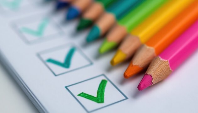 Quality assurance checklist compliance and regulatory approval with colorful pencils marking completed tasks on paper