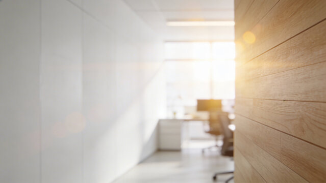 A large white wall was in an office with light wooden floors and a modern design with glass walls. The room had concrete ceilings and lighting from windows