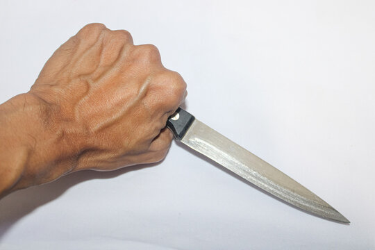 Tight grip holds a knife, sharp and ready