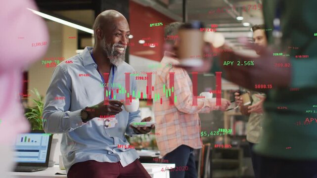 Man sitting in kitchen with cup laughing as banter and chart sparking market overlay
