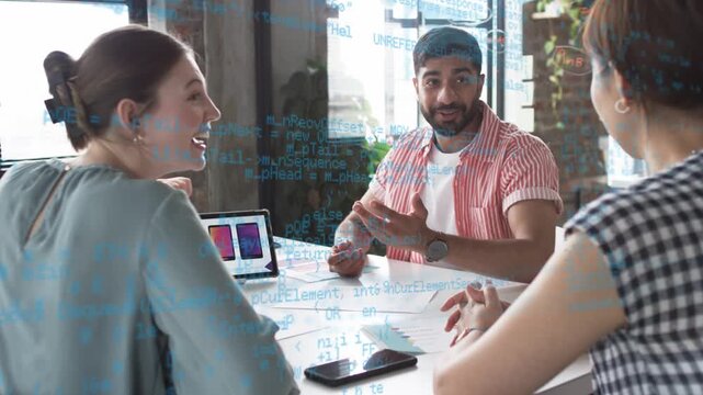Man presenting tablet and leading design meeting reviewing mockups, blue code drifting across table