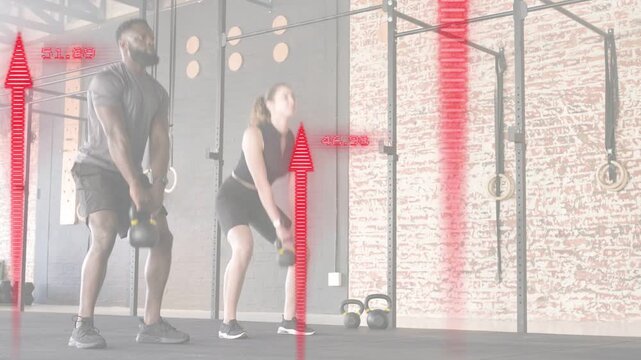 Fitness partners lowering hips and swinging kettlebells in gym, red arrows tracking power metrics