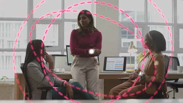 Female business team reviewing data spot appearing pink dashed circles expanding over group