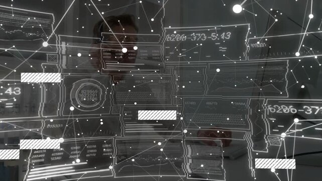 Engineer using keyboard behind schematic overlay, updating nodes, bars, numbers for analysis