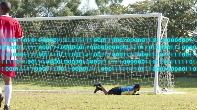 Red soccer player shooting, keeper diving, stopping goal, binary overlay showing blue team cheering