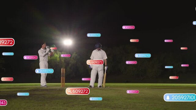 Cricket batsman preparing, bowler running releasing ball, badges drifting, guarding floodlit stumps