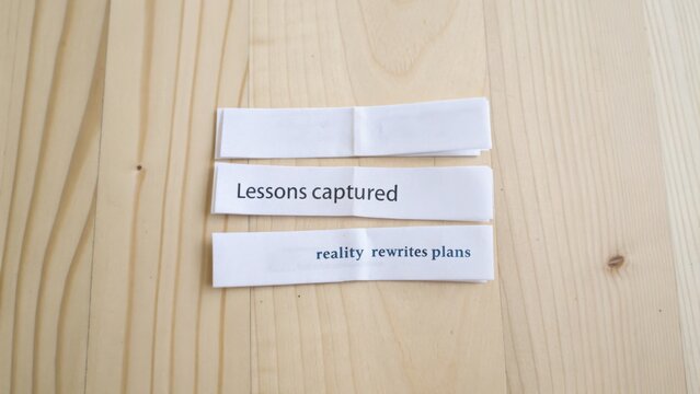 Thought-provoking quotes about learning and adaptability on wooden background for inspiration and motivation